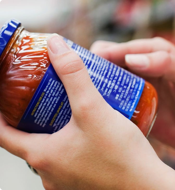 Reading a jar label.