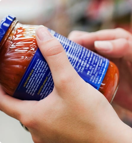 Reading a jar label.