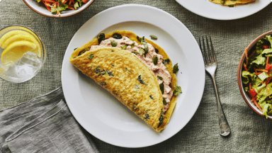 Spinach and sundried tomato stuffed crepe omelette ready to be eaten. Spinach and sundried tomato stuffed crepe omelette ready to be eaten.