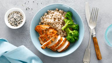 Grilled chicken with cooked barley and broccoli in a bowl ready to be eaten for dinner. Grilled chicken with cooked barley and broccoli in a bowl ready to be eaten for dinner.