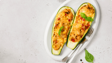 Cooked zucchini stuffed with turkey and breadcrumbs on a plate. Cooked zucchini stuffed with turkey and breadcrumbs on a plate.