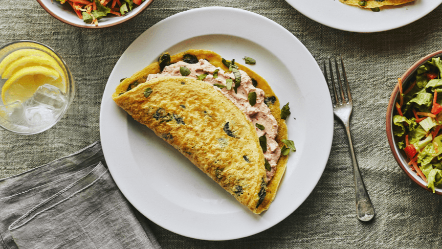 Spinach and sundried tomato stuffed crepe omelette ready to be eaten. Spinach and sundried tomato stuffed crepe omelette ready to be eaten.