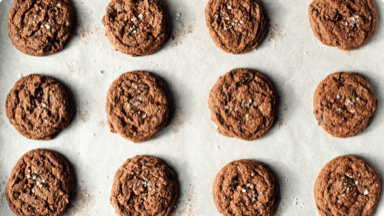 Fudgy chocolate cookies on parchment paper. Fudgy chocolate cookies on parchment paper.