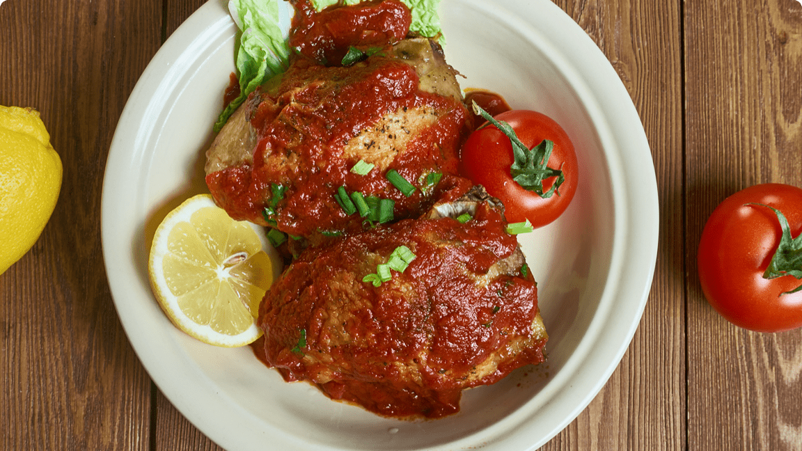 Cooked chicken coated in berberi sauce plated for dinner. Cooked chicken coated in berberi sauce plated for dinner.