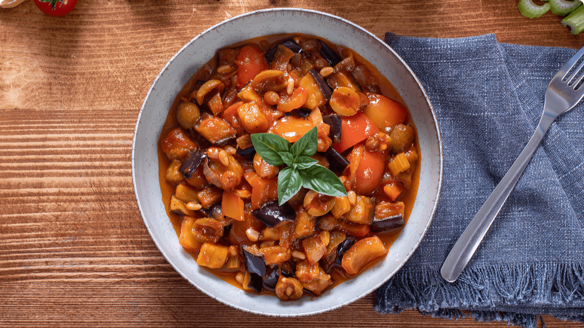 Stewed eggplant and tomato in bowl ready to be eaten for dinner. Stewed eggplant and tomato in bowl ready to be eaten for dinner.