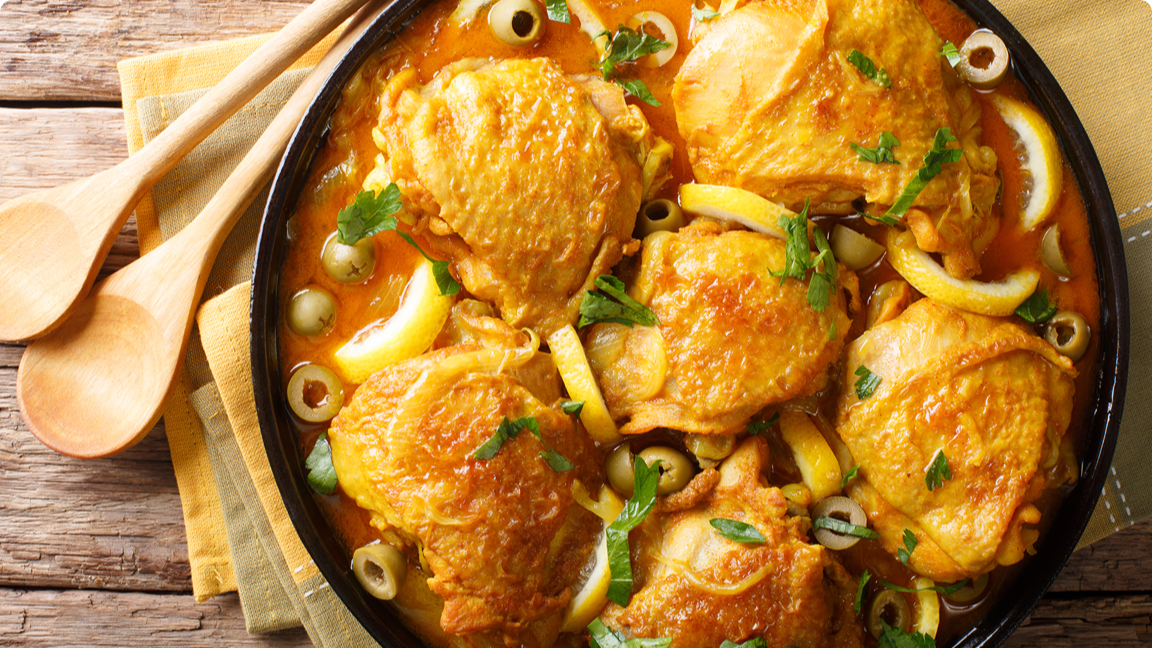 Chicken thighs cooked in a Moroccan-inspired sauce waiting to be served. Chicken thighs cooked in a Moroccan-inspired sauce waiting to be served.