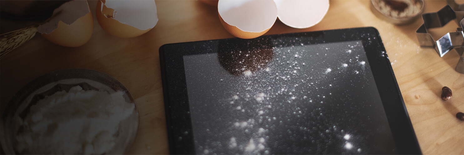 iPad dusted with flour next to baking ingredients
